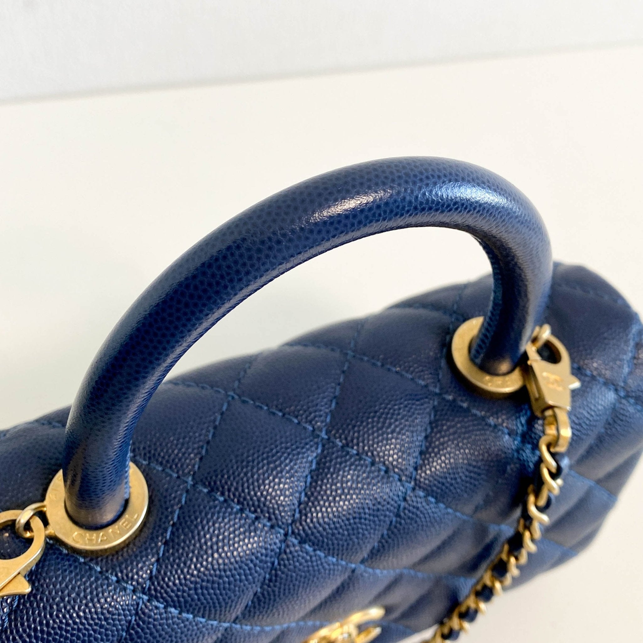 CHANEL Coco Handle Navy Grain Calf Leather Top Handle Bag with Gold Hardware, in Sold by HIVE PRELOVED Crossbody bags